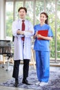 Asian young handsome professional successful male doctor in white lab coat standing smiling crossed arms holding stethoscope with Royalty Free Stock Photo