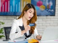 Asian young happy cheerful beautiful millennial professional successful female businesswoman in formal suit sitting smiling Royalty Free Stock Photo