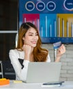 Asian young happy cheerful beautiful millennial professional successful female businesswoman in formal suit sitting smiling Royalty Free Stock Photo