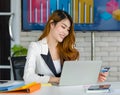 Asian young happy cheerful beautiful millennial professional successful female businesswoman in formal suit sitting smiling Royalty Free Stock Photo