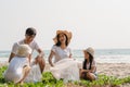 Asian young happy family activists collecting plastic waste on beach. Asia volunteers help to keep nature clean up and pick up Royalty Free Stock Photo