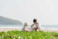 Asian young happy family activists collecting plastic waste on beach. Asia volunteers help to keep nature clean up and pick up Royalty Free Stock Photo