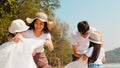 Asian young happy family activists collecting plastic waste on beach. Asia volunteers help to keep nature clean up and pick up Royalty Free Stock Photo