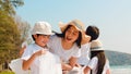 Asian young happy family activists collecting plastic waste on beach. Asia volunteers help to keep nature clean up and pick up Royalty Free Stock Photo