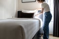 Asian young lady making bed,change pillowcase sheet and bedding in her room,teenage girl cleaning,tidying up the bedroom,enjoy Royalty Free Stock Photo