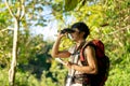 Asian young man with binoculars hiking in forest. Summer vacation Royalty Free Stock Photo