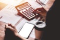 Asian young man in blue shirt holding pen working ,Calculate tax lead to liquidation, With Sunset light vintage style Royalty Free Stock Photo