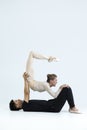 Asian Young Man and Caucasian Woman Performing As Ballet Dancers Over Grey in Studio During Suppots As Classical Dance With Royalty Free Stock Photo