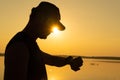 Asian young man checking time on  fitness watch after exercise near sunset Royalty Free Stock Photo