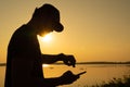 Asian young man checking time on his sports watch near sunset Royalty Free Stock Photo