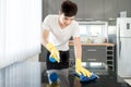 Asian Young Man Cleaning Modern Kitchen at Home