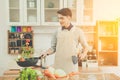 Asian young man is cooking Royalty Free Stock Photo