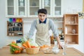 Asian young man is cooking,Portrait of young man looking recipe Royalty Free Stock Photo