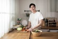 Asian young man cooking , preparing breakfast with healthy food in kitchen at home , healthy lifestyle Royalty Free Stock Photo