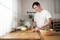 Asian young man cooking , preparing breakfast with healthy food in kitchen at home , healthy lifestyle Royalty Free Stock Photo