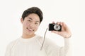 Asian young man with digital camera Royalty Free Stock Photo