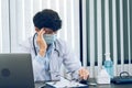 Asian young man doctor being exhausted and burnout in the office room