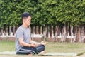 Young man doing yoga outdoors in meditate lotus pose Royalty Free Stock Photo