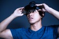 The Asian young man with virtual reality glasses. experiences VR hololens headset in studio with advanced technology Royalty Free Stock Photo