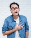 Asian young man having heart attack Royalty Free Stock Photo