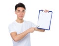 Asian young man pen point to white paper of clipboard Royalty Free Stock Photo