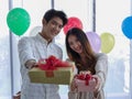 The asian young man proposed the beautiful woman for marry with the engagement ring in red heart box Royalty Free Stock Photo