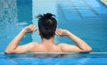 Asian young man relaxing on a swimming pool Royalty Free Stock Photo