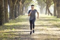 Asian young Man running in the forest on foggy at morning