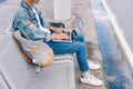 Asian young man sitting on the chair at the airport bus stop and Royalty Free Stock Photo