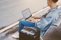 Asian young man sitting on the chair at the airport bus stop and Royalty Free Stock Photo