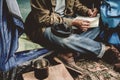 Asian young man sitting is holding a pen writing note of letter memorize memories on book in outside the tent. Loneliness