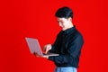 Asian young man smart and handsome sitting on chair folded leg and hold tablet on hand while feeling excited. Shooting at studio