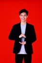 Asian young man smart and handsome standing look at camera with smile on face.Posing in hand holding something Shoot in studio Royalty Free Stock Photo