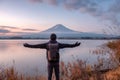 Asian young man stand looking Mount Fuji on Kawaguchiko Lake at