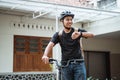 Asian young man standing with folding bike while looking her watch Royalty Free Stock Photo