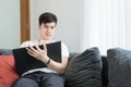 Asian Young Man Thinking and Wondering While Writing a Paper at Royalty Free Stock Photo