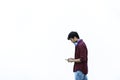 Asian young man using mobile phone outdoor - Asian social influencer having fun with new trends smartphone apps - Generation z, Royalty Free Stock Photo