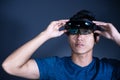 The Asian young man with virtual reality glasses. experiences VR hololens headset in studio with advanced technology Royalty Free Stock Photo