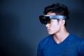 The Asian young man with virtual reality glasses. Experience VR hololens headset in studio with advanced technology