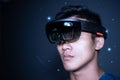 The Asian young man with virtual reality glasses. experiences VR hololens headset in studio with advanced technology Royalty Free Stock Photo