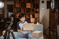 Asian young man vlogger recording new vlog about unboxing review
