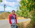 An Asian young man walking on rural road Royalty Free Stock Photo