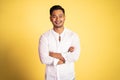 asian young man wearing white shirt smiling with arms crossed Royalty Free Stock Photo