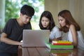 Asian young man and woman sitting pointing studying examining