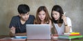 Asian young man and woman sitting pointing studying examining