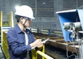 Asian young men Check the machine inside the industrial factory