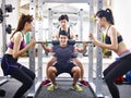 Young asian man lifting weight in gym Royalty Free Stock Photo