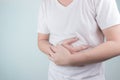 Asian Young men are suffering from stomach ulcers. gastritis Caused by the infection of H. pylori bacteria healthcare and health Royalty Free Stock Photo