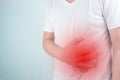 Asian Young men are suffering from stomach ulcers. gastritis Caused by the infection of H. pylori bacteria healthcare and health Royalty Free Stock Photo