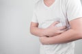 Asian Young men are suffering from stomach ulcers. gastritis Caused by the infection of H. pylori bacteria healthcare and health Royalty Free Stock Photo